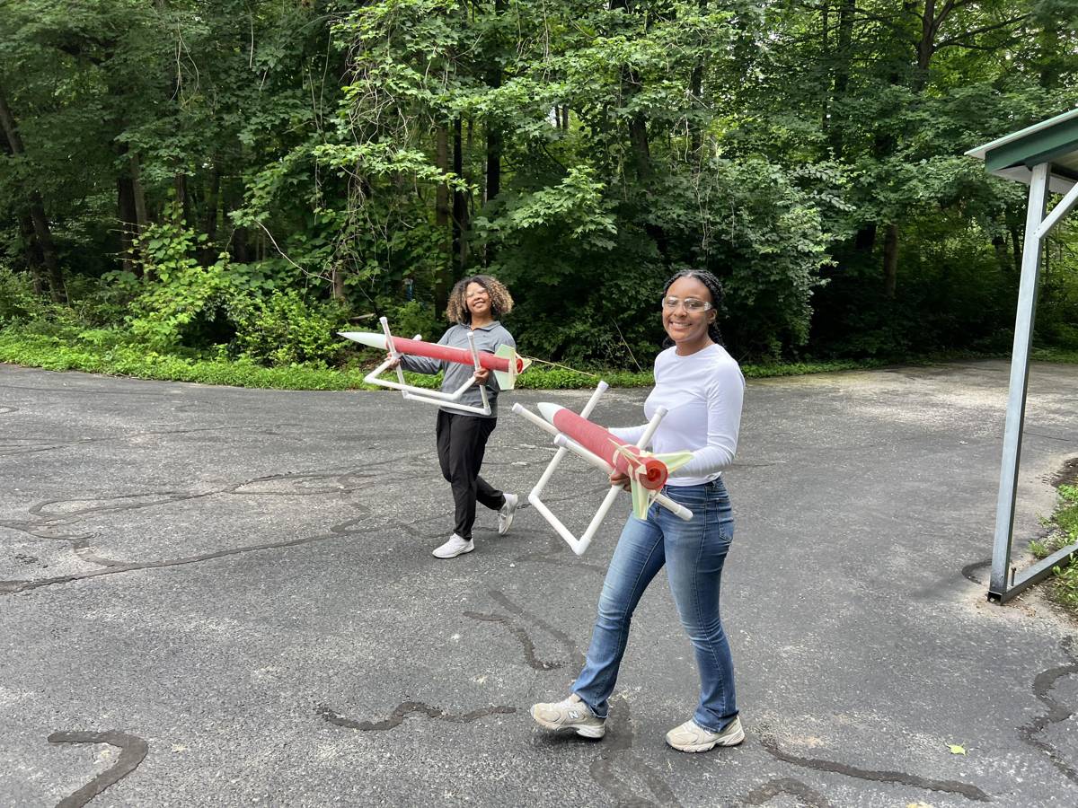 Volunteers carrying finished rockets